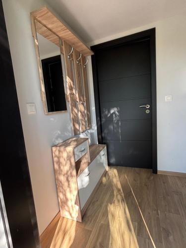 a hallway with a door and a mirror at Containers aménagé au cœur des chants des grenouilles in Hotton