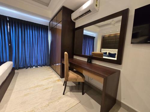 a hotel room with a desk and a bed at Ocean Breeze Condo in Negombo