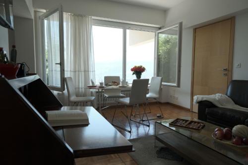 a living room with a couch and a table with chairs at Casa-Cleo in Lugano