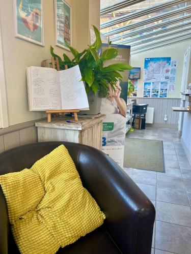 a leather couch in a store with a yellow blanket at BRIT HOTEL Lannion-Perros Guirec in Lannion