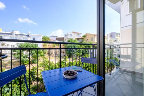 a blue table and chairs on a balcony with a view at Theon Urban Suites by Nomads in Paphos City