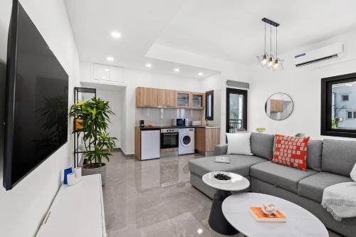 a living room with a couch and a table at Theon Urban Suites by Nomads in Paphos City