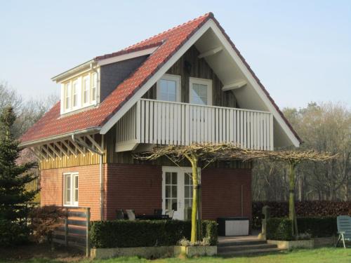 a house with a red roof at Holiday Home in Well near Maasduinen Park in Knikkerdorp