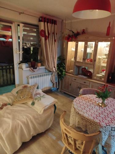 a bedroom with a bed and a table and a table and a tableablish at Retro apartament Lukas in Ostrowsko