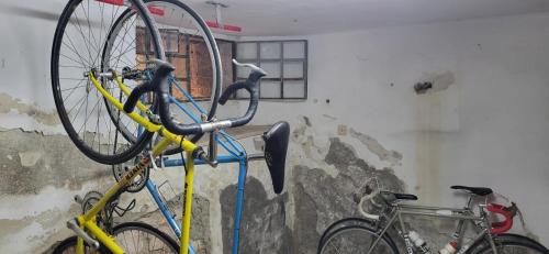 two bikes are hanging on a wall at Il Pincio Apartment, Cagli in Cagli