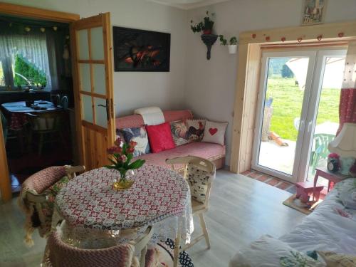 a living room with a table and a couch at Retro apartament Lukas in Ostrowsko