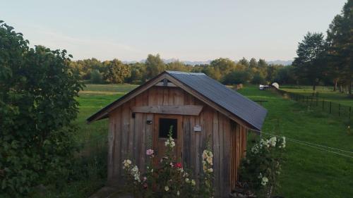 a smallshed in the middle of a field at Retro apartament Lukas in Ostrowsko