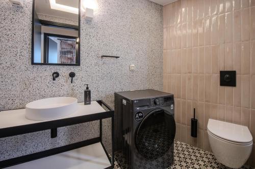 a bathroom with a washing machine and a sink at Porto Searene in Nafplio