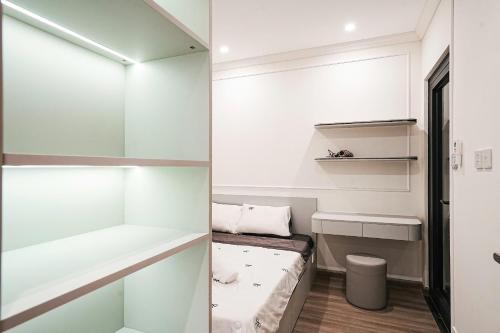 a small room with white walls and a walk in closet at The Place- Vinhome Grand Park Q9 in Long Bình