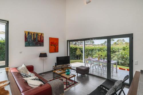 a living room with a couch and a table at Sesimbra Villa with Private Pool and Garden - Total Privacy in Sesimbra