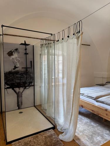 a bedroom with a bed and a glassoir with a window at Stadtjuwel am Neusiedlersee in Rust
