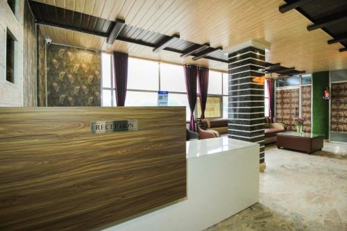 a lobby with a reception desk in a building at HoTEL MEHRAZ in Haldwāni