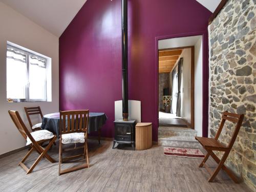 a living room with a fireplace and a table and chairs at Holiday Home Saint-Gilles near Beach in Saint-Gilles-les-Bois