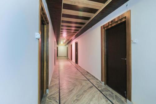 an empty hallway with a door in a room at HoTEL MEHRAZ in Haldwāni