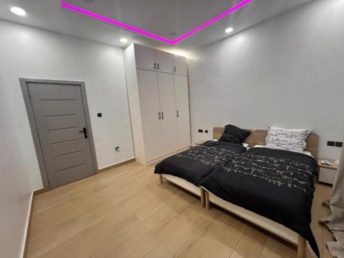 a bedroom with a bed and a purple light at Villa de l'atlantique in Abomey-Calavi
