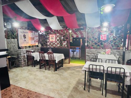 a dining room with tables and chairs and a ceiling at Jura 88 Guesthouse in Hua Hin