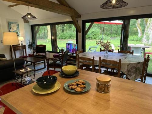 a living room with a table with food on it at Gite du cache in Labrit