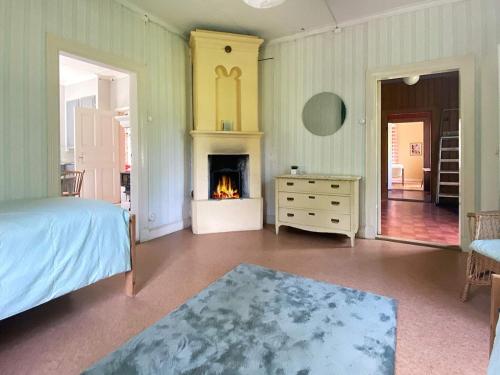 a bedroom with a bed and a fireplace at 7 person holiday home in SANDHEM-By Traum in Sandhem