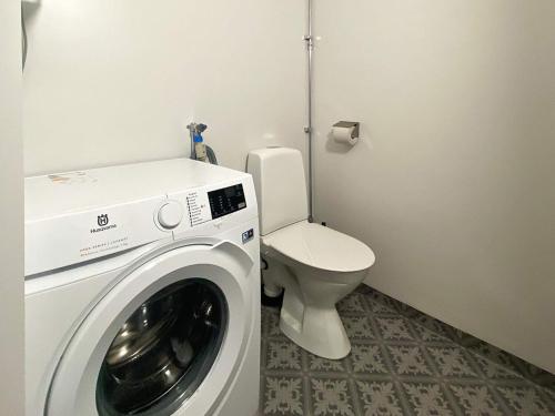 a bathroom with a washing machine and a toilet at 7 person holiday home in SANDHEM-By Traum in Sandhem