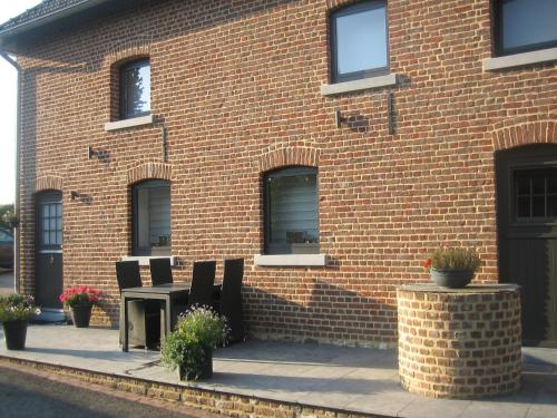 a brick building with a table and chairs in front of it at Holiday Home in Epen with Garden & BBQ in Epen