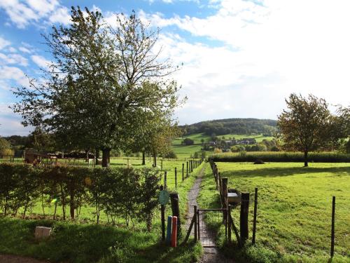 a path through a field with a fence and trees at Holiday Home in Epen with Garden & BBQ in Epen