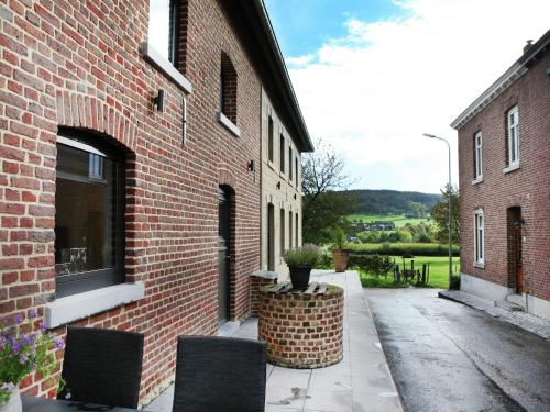 a brick building with two chairs and a window at Holiday Home in Epen with Garden & BBQ in Epen