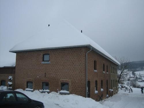a large brick building with snow on the roof at Holiday Home in Epen with Garden & BBQ in Epen