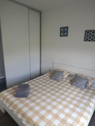 a bed with two pillows on it in a room at Cube Apartamenty in Lublin