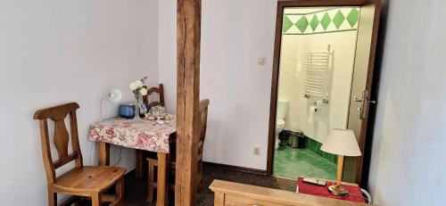a room with a table and a mirror and a table and chair at Karczma na Woli in Biłgoraj