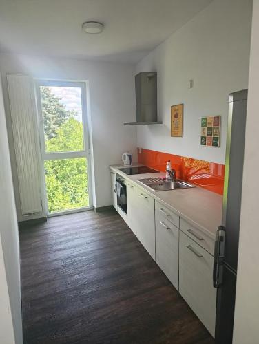 a kitchen with a sink and a stove at Cube Apartamenty in Lublin