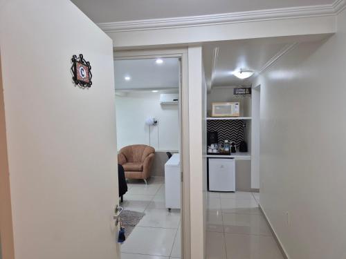 a hallway with a living room and a clock on a wall at Edelweiss Haus in Feliz