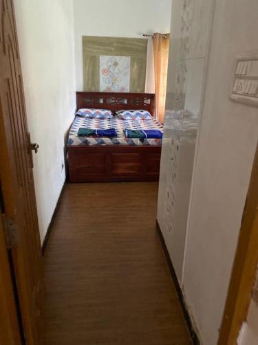 a small bedroom with a bed and a hallway at Ckcm Resort in Dindigul