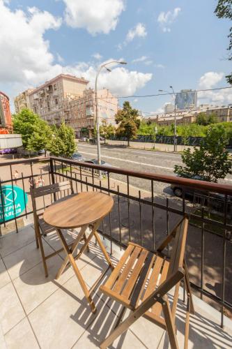 a table and chairs on a balcony with a street at Idea Design Apart-Hotel in Kyiv