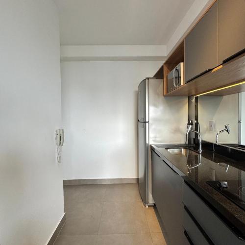 a kitchen with a stainless steel refrigerator in it at Apartamentos Prime - Jardins in Sao Paulo