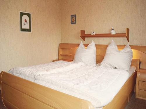 a bedroom with a bed with white sheets and pillows at Furnished Bungalow With Peaceful Neighbourhood in Meschede
