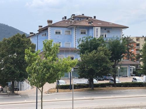 a large blue building on the side of a street at Residence Hotel Azzurro in LʼAquila