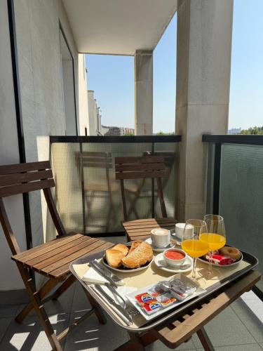 a tray of food on a table on a balcony at Hotel Real in Lleida