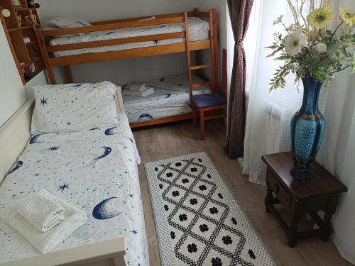 a bedroom with two bunk beds and a vase of flowers at Bella Terra 2 in L'Ampolla