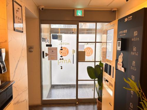 a door to a gym with a sign on it at Hotel Amy in Incheon