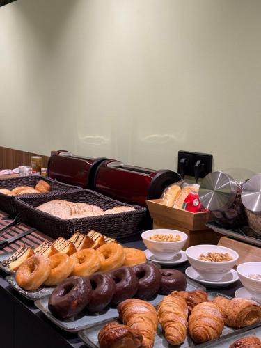 a table topped with lots of different types of donuts and pastries at Hotel Real in Lleida