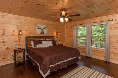 a bedroom with a bed and a ceiling fan at Always Dreaming by American Patriot Getaways in Hatchertown