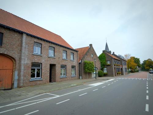 an empty street in a town with brick buildings at apartment near the Belgian border in Roosteren