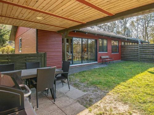 a patio with a table and chairs and a house at 5 person holiday home in Silkeborg-By Traum in Silkeborg