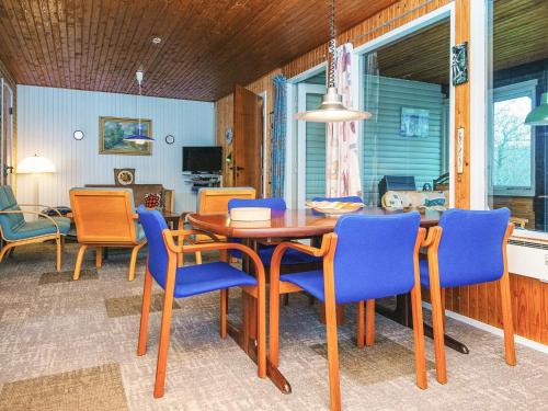 a dining room with a table and blue chairs at 5 person holiday home in Silkeborg-By Traum in Silkeborg