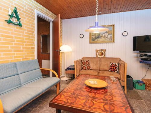 a living room with a couch and a table at 5 person holiday home in Silkeborg-By Traum in Silkeborg