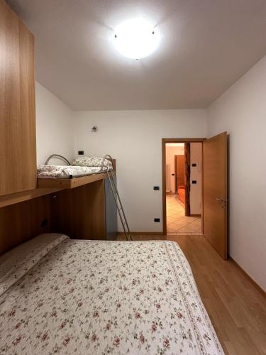 a bedroom with a bed and a room with a hallway at Casa Dorigoni Molveno in Molveno
