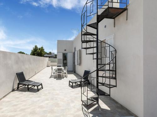 a spiral staircase on the side of a white building at Modern Villa Near Trapani in Locogrande