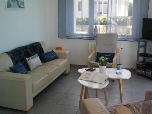 a living room with a couch and a table at Holiday Home in Audresselles by Seacoast in Audinghen