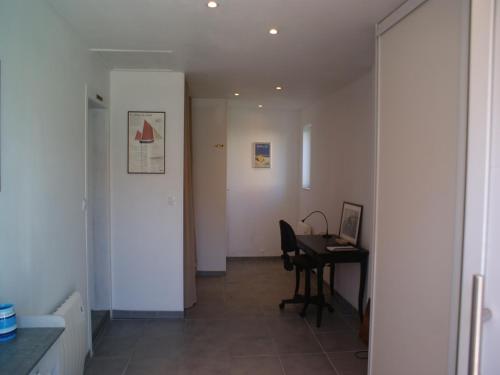 a hallway with a desk and a table in a room at Holiday Home in Audresselles by Seacoast in Audinghen