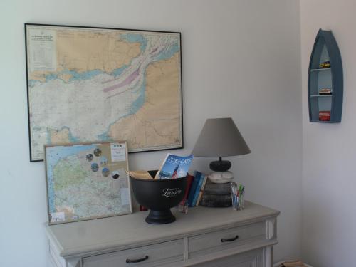 a map on top of a dresser with a lamp at Holiday Home in Audresselles by Seacoast in Audinghen